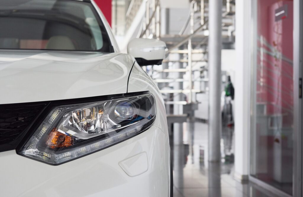 The headlights and the hood of a new luxury car